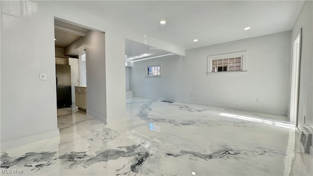 unfurnished room with recessed lighting, marble finish floor, and baseboards