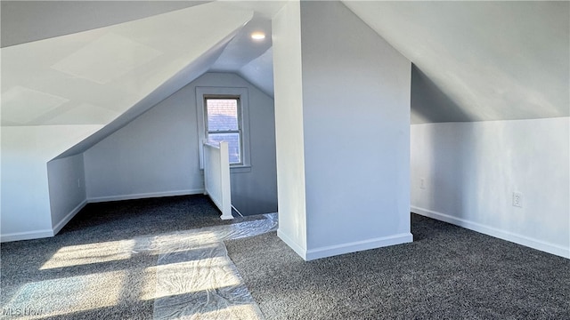 additional living space with vaulted ceiling, carpet, and baseboards