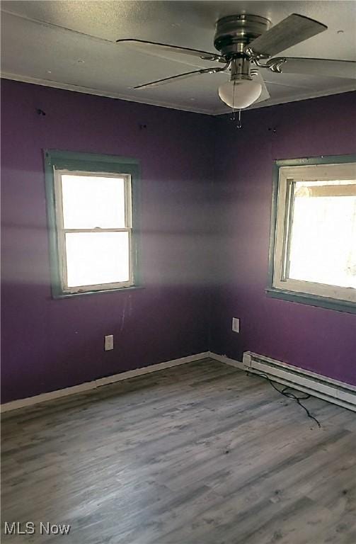 135 Paradise Blvd, Madison, OH 44057 - spare room featuring wood finished floors, a ceiling fan, baseboards, and baseboard heating