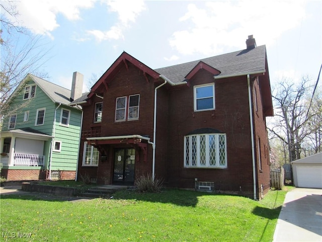 view of front of property with an outbuilding, brick siding, a front yard, and a chimney
