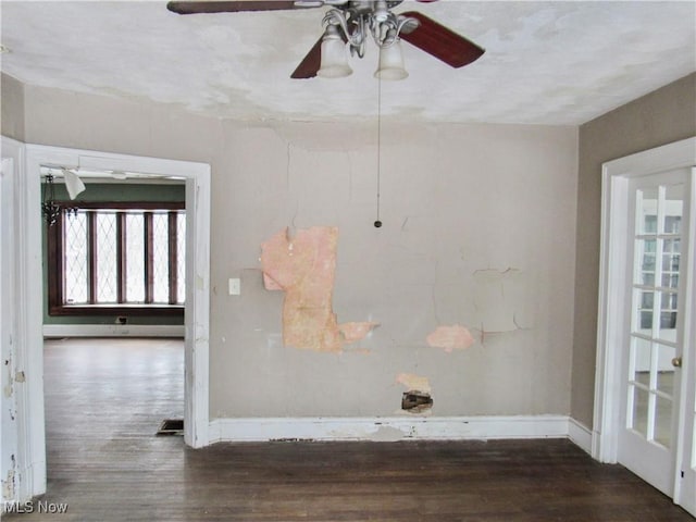 spare room featuring baseboards, a ceiling fan, and wood finished floors