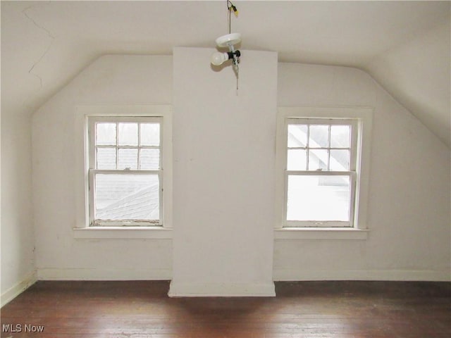 bonus room with lofted ceiling, a healthy amount of sunlight, and dark wood-style floors