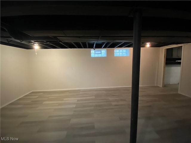 below grade area with wood finished floors and baseboards