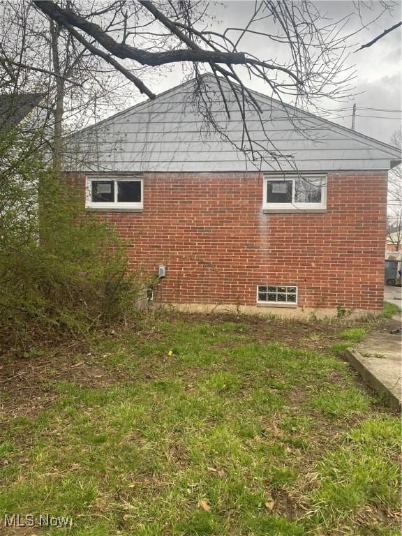 view of side of home featuring brick siding