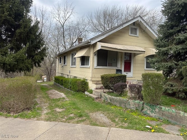 bungalow featuring a chimney