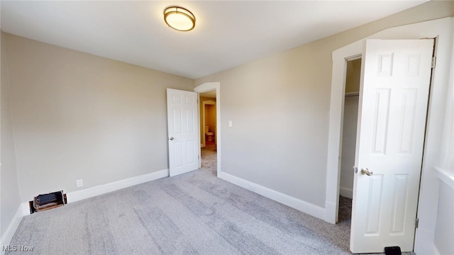 unfurnished bedroom with baseboards and carpet