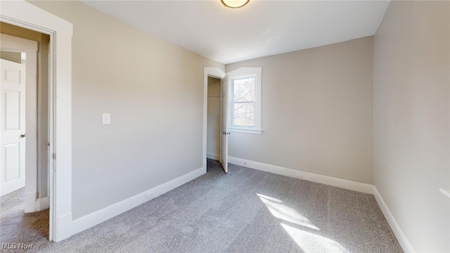 spare room with carpet floors and baseboards
