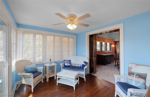 living area with ceiling fan and wood finished floors