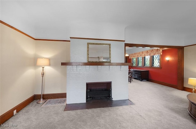 unfurnished living room featuring a fireplace with flush hearth, baseboards, carpet, and ornamental molding