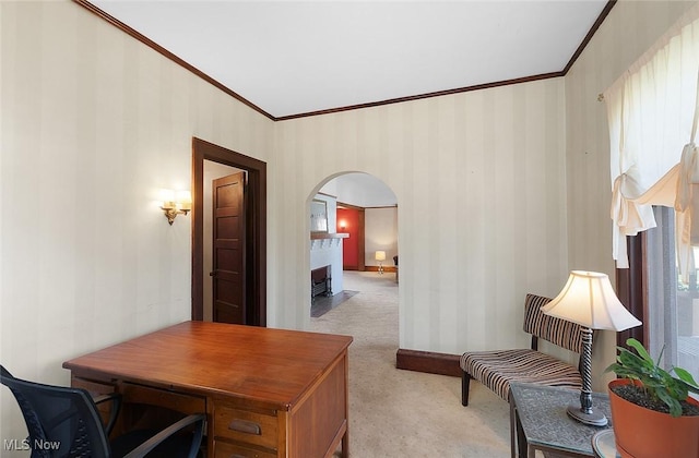 office space featuring light carpet, arched walkways, wallpapered walls, and crown molding