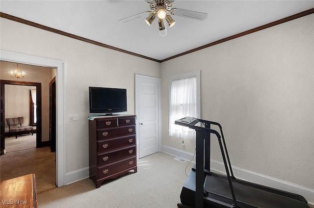 exercise area with light carpet, ornamental molding, baseboards, and ceiling fan