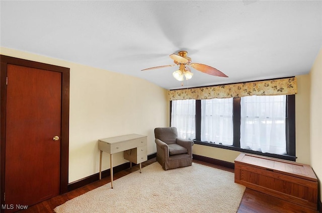 living area with ceiling fan, baseboards, and wood finished floors