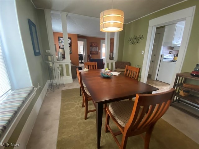 dining area with light carpet and a healthy amount of sunlight