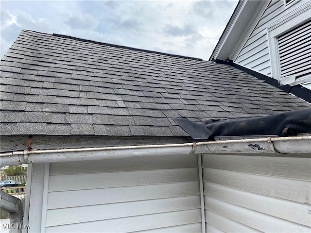 exterior details featuring a shingled roof