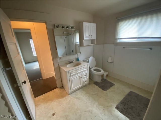 bathroom with tile patterned floors, vanity, a shower with door, and toilet