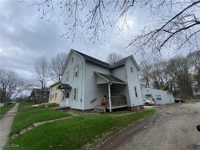 view of home's exterior featuring dirt driveway and a yard
