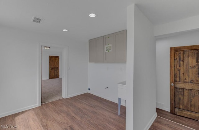 unfurnished room featuring recessed lighting, wood finished floors, visible vents, and baseboards