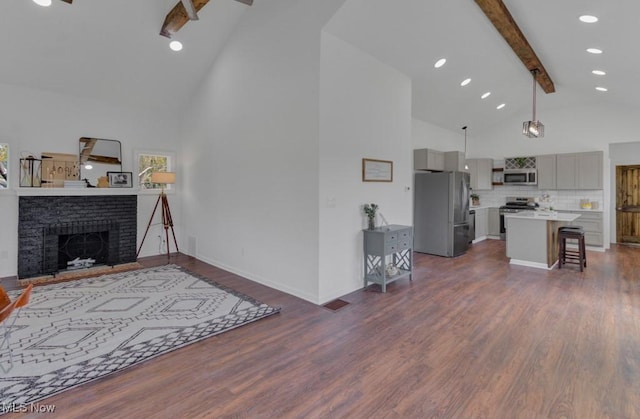 living room featuring beamed ceiling, a fireplace, dark wood-style floors, and high vaulted ceiling