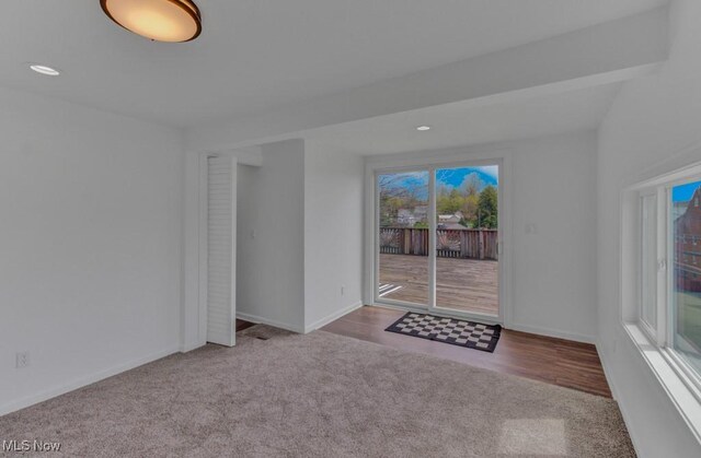 interior space with recessed lighting, carpet floors, and baseboards