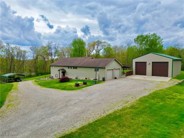 view of front facade featuring an outbuilding, a front yard, and a garage