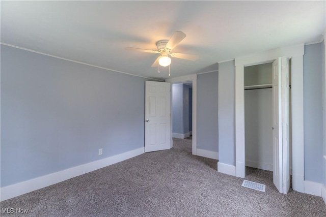unfurnished bedroom with baseboards, visible vents, carpet, a ceiling fan, and a closet