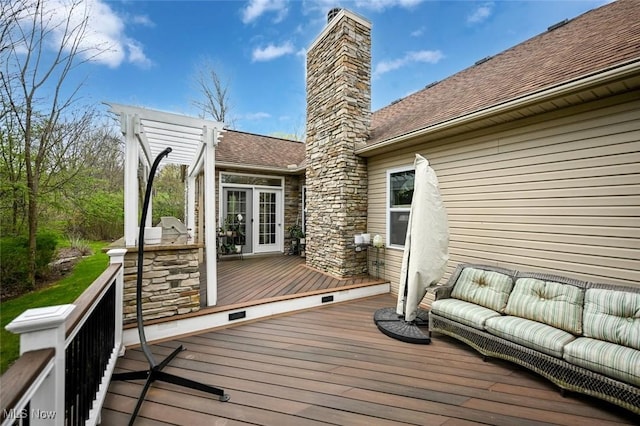 wooden terrace with an outdoor living space