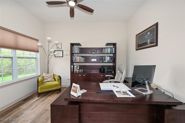 office area featuring baseboards, wood finished floors, and ceiling fan
