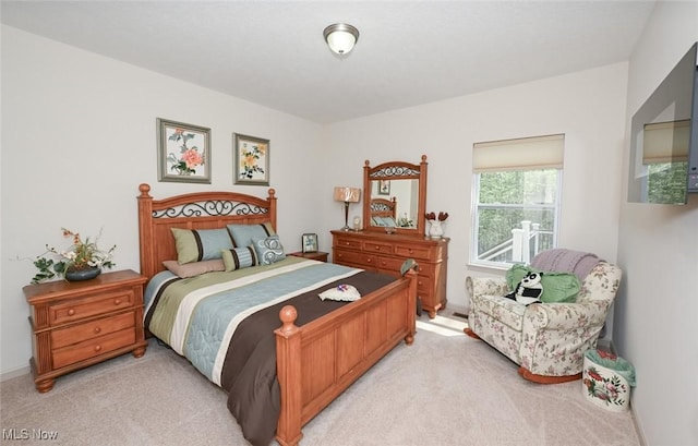 bedroom featuring light carpet