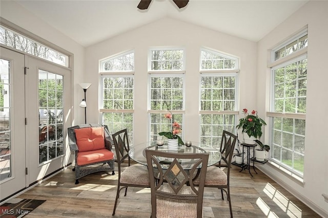 sunroom / solarium featuring french doors, wood finished floors, and plenty of natural light