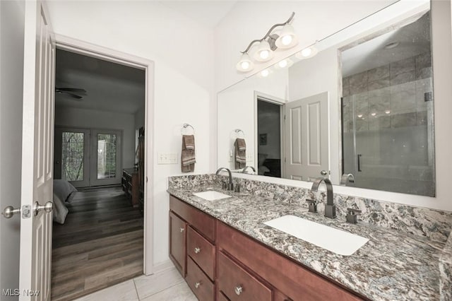 ensuite bathroom with ensuite bath, french doors, and a sink