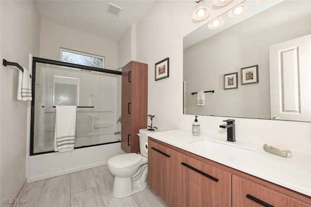 full bath with toilet, visible vents, vanity, and shower / bath combination with glass door