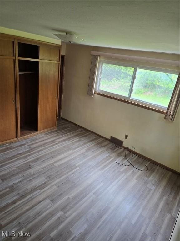 3742 Concord Dr, Beachwood, OH 44122 - unfurnished bedroom featuring wood finished floors, a closet, and baseboards