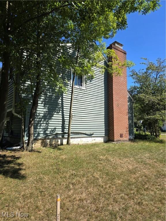 3742 Concord Dr, Beachwood, OH 44122 - view of side of home featuring a yard, a chimney, and crawl space