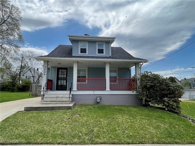 7706 Connecticut Ave, Garfield Heights, OH 44105 - bungalow featuring a front lawn, roof with shingles, and a porch
