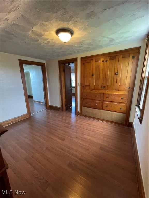 7706 Connecticut Ave, Garfield Heights, OH 44105 - empty room featuring baseboards and wood finished floors