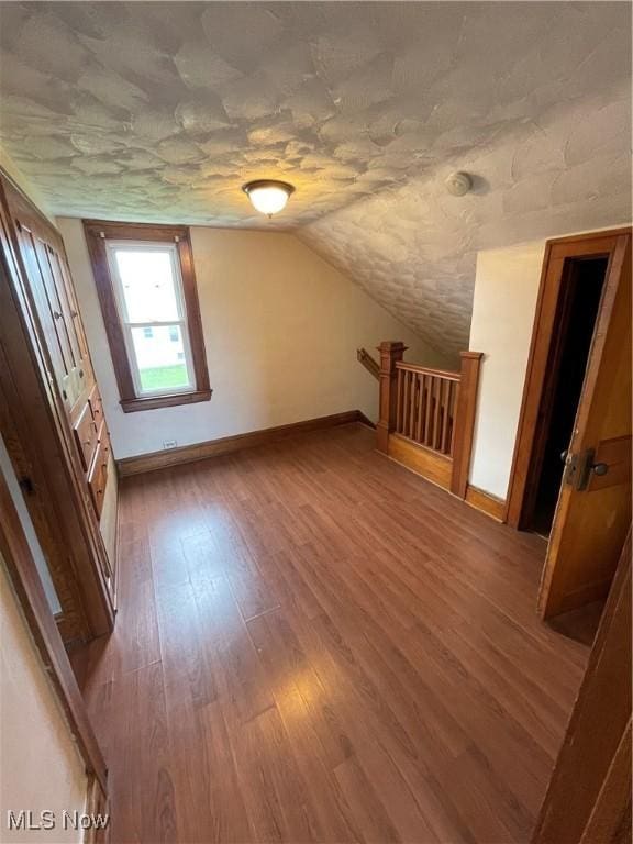 7706 Connecticut Ave, Garfield Heights, OH 44105 - additional living space with vaulted ceiling, wood finished floors, and baseboards