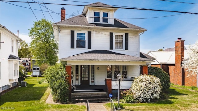 traditional style home with central AC unit, a chimney, a front lawn, a shingled roof, and a porch
