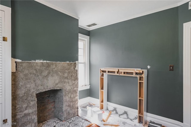 bathroom featuring a fireplace with flush hearth, visible vents, and ornamental molding