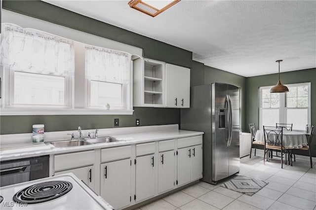 kitchen with stainless steel fridge with ice dispenser, white cabinetry, a sink, and light countertops