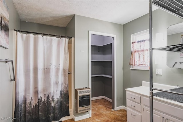 bathroom featuring tile patterned floors, heating unit, vanity, a walk in closet, and a shower with shower curtain