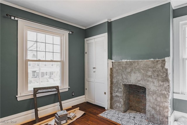 living area with a fireplace with flush hearth, baseboards, crown molding, and dark wood-style floors