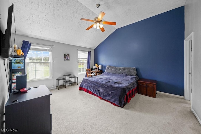bedroom with vaulted ceiling, a textured ceiling, and carpet