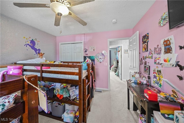 bedroom with a ceiling fan, baseboards, carpet floors, and a textured ceiling