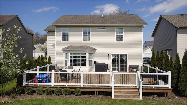 rear view of property featuring a deck