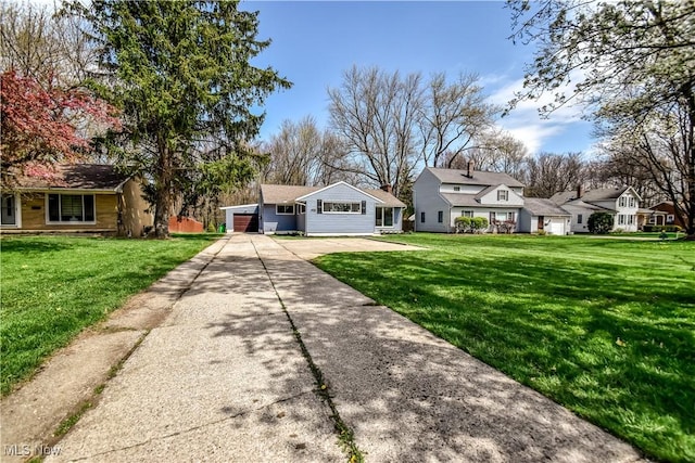 traditional-style house with a garage, a front lawn, and concrete driveway