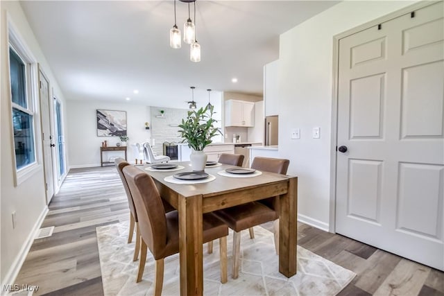 dining space with recessed lighting, baseboards, and light wood-style flooring