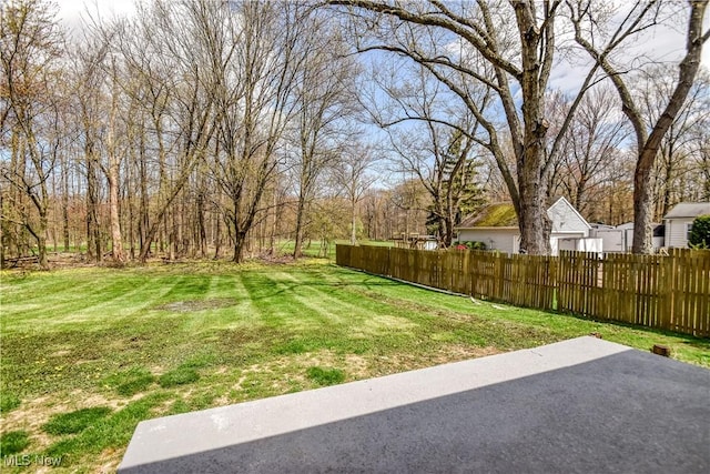 view of yard with fence and a patio
