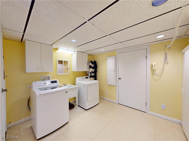 washroom with washer and dryer, cabinet space, baseboards, and recessed lighting