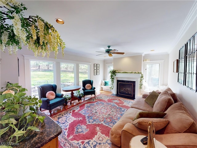 living area featuring ceiling fan, crown molding, a fireplace with flush hearth, wood finished floors, and recessed lighting