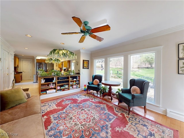 living area with ornamental molding, a ceiling fan, light wood-type flooring, recessed lighting, and baseboards